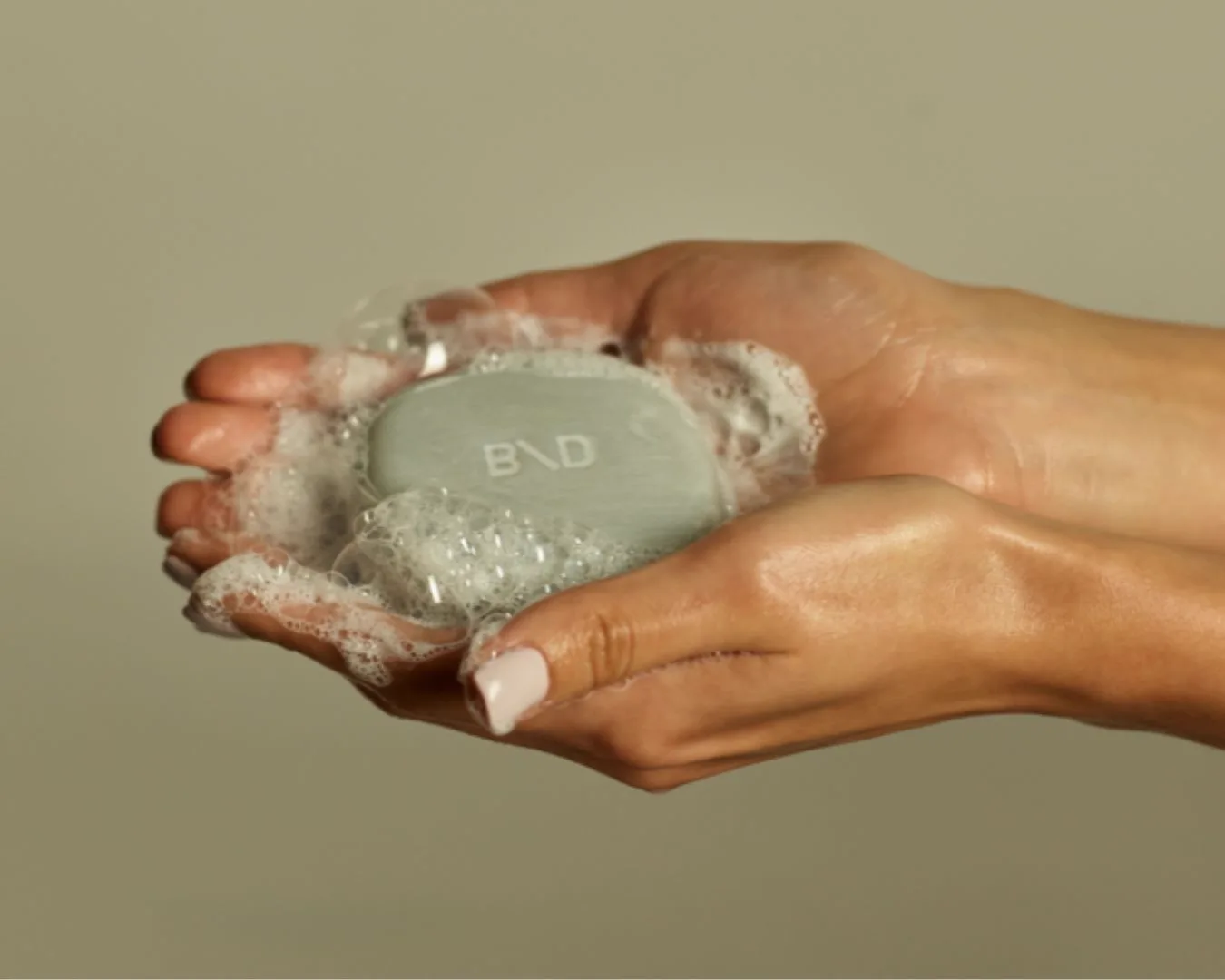 Hands lathering Beauty Disrupted soap bar