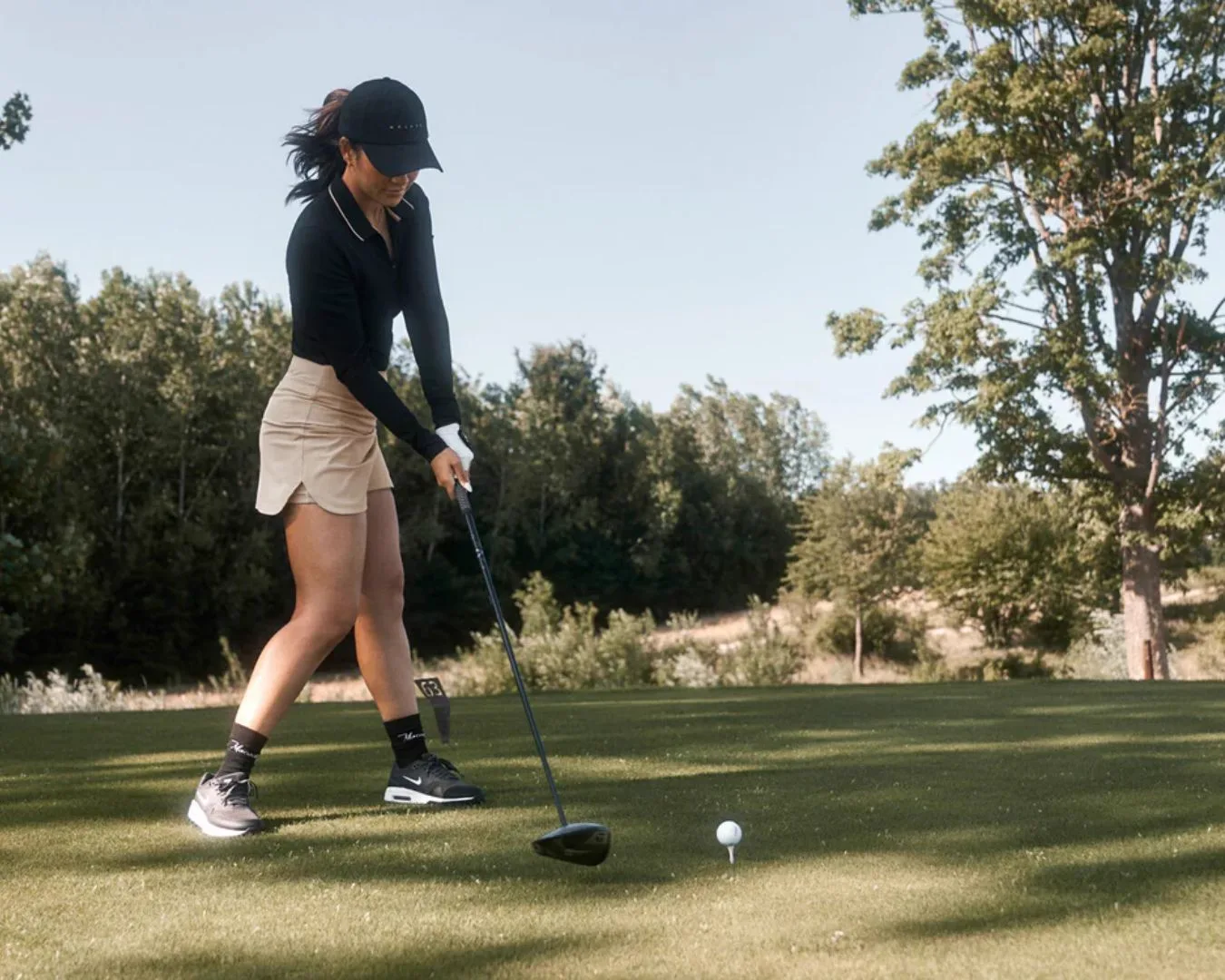 Woman golfer preparing to tee off