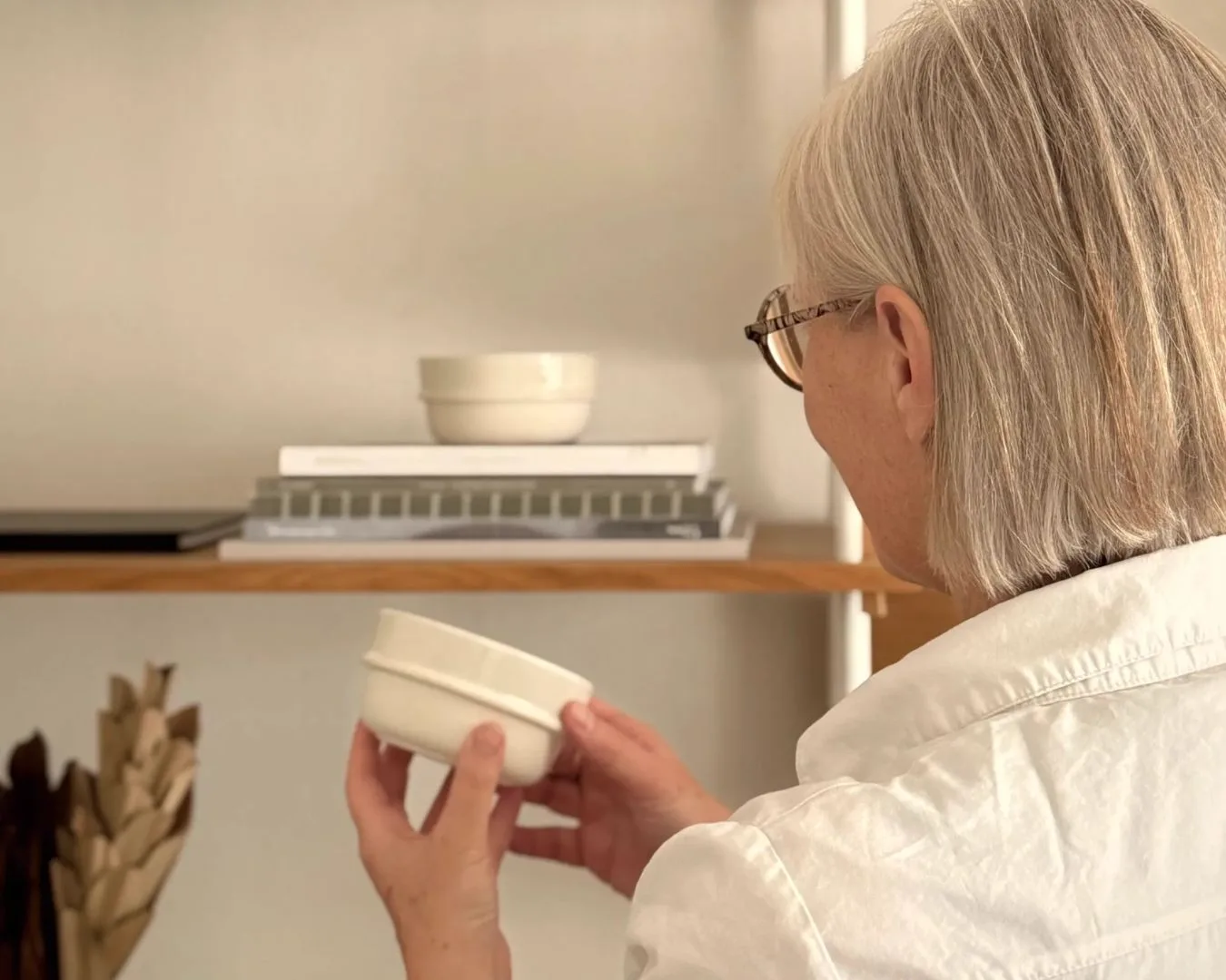Woman examining Norlii ceramic bowl